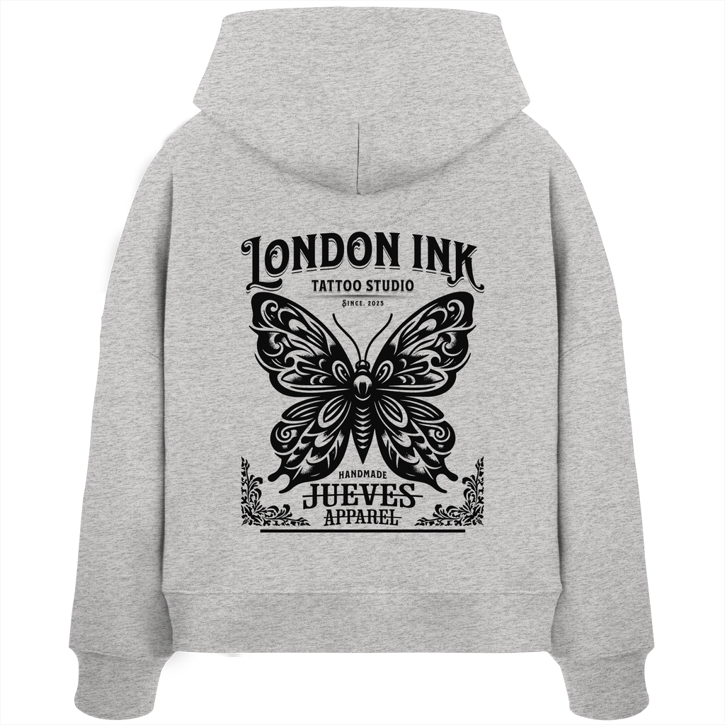Rückansicht eines grauen Damen Oversized Boxcut Hoodies von Jueves Apparel aus 100 % Baumwolle, 300 g/m² – markanter Rückendruck und urbaner Streetwear-Look mit modernem Schnitt. 